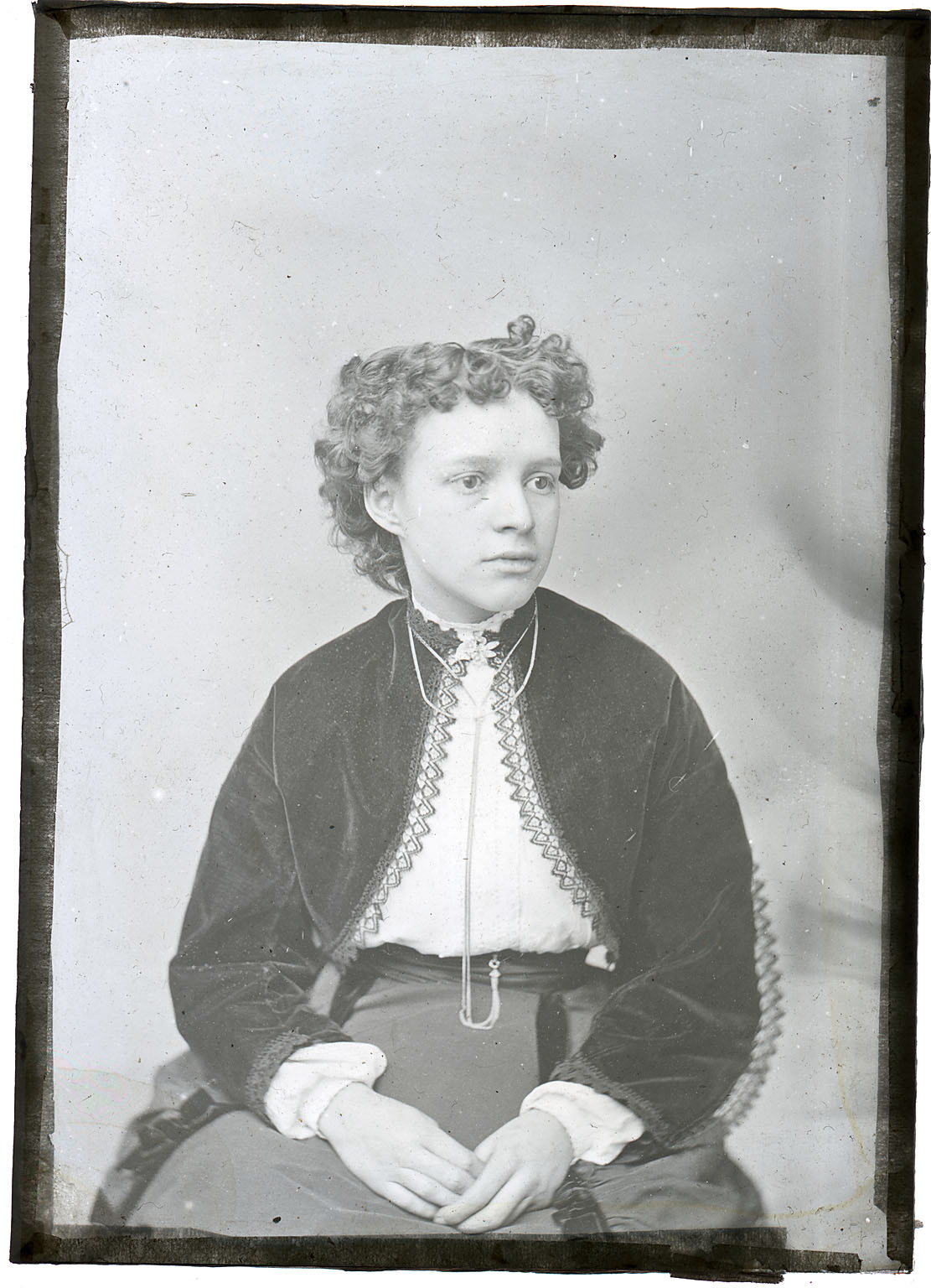 Unidentified young woman with curly hair and black jacket