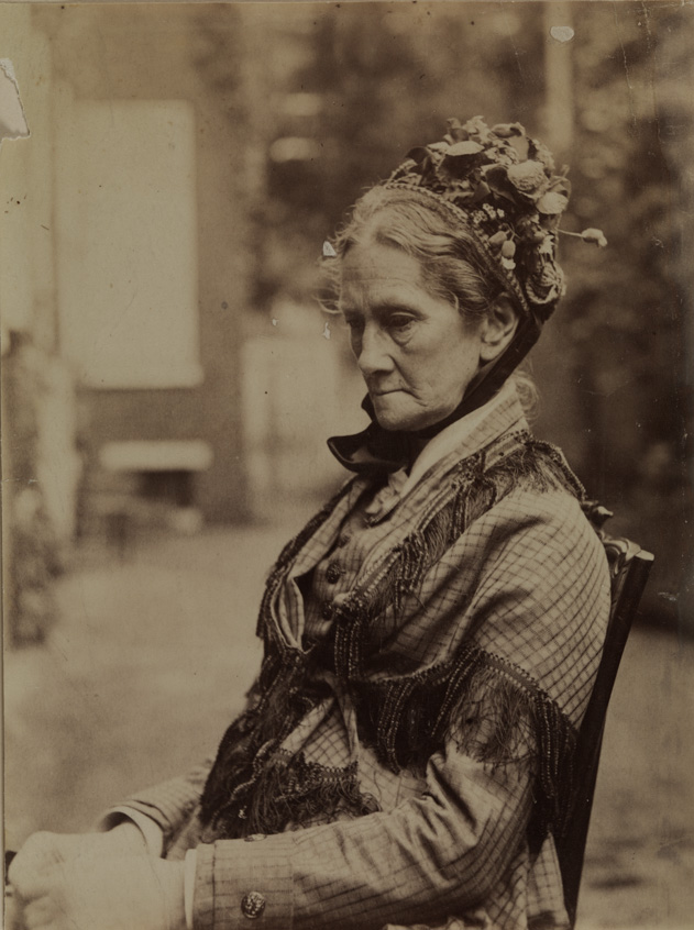Mrs. William Macdowell wearing shawl and bonnet, sitting, facing left