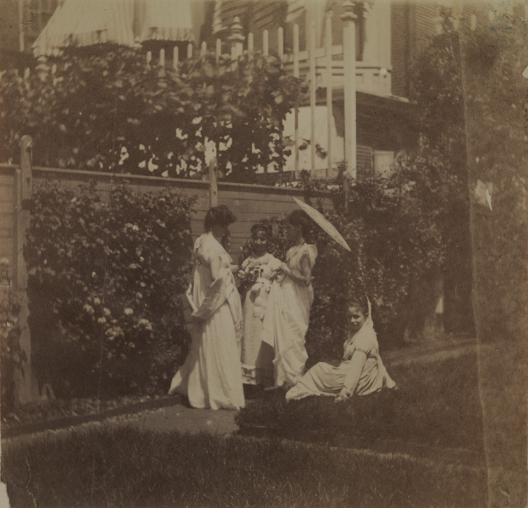 Four women wearing Empire dresses