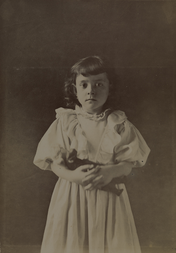 Unidentified girl with doll, 3/4 length