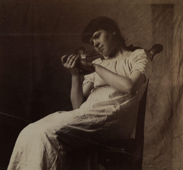 Girl sitting in Chippendale chair, hands clasped