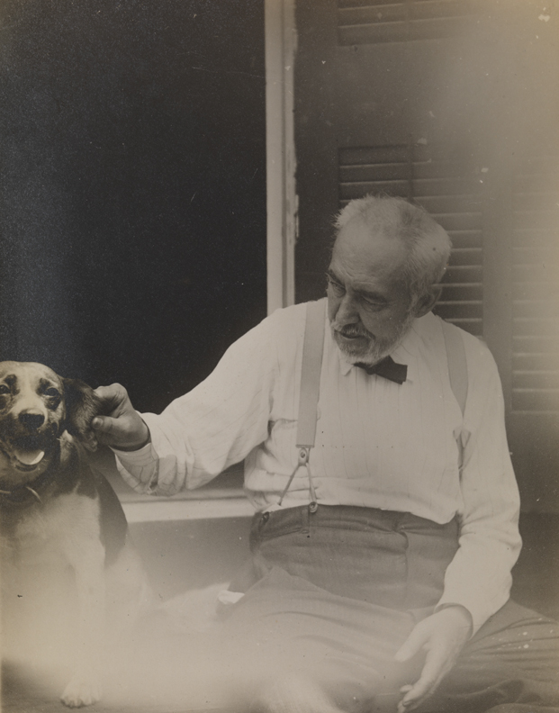 Thomas Eakins tweaking his dog's ear in doorway of the family home at 1729 Mount Vernon Street, Philadelphia