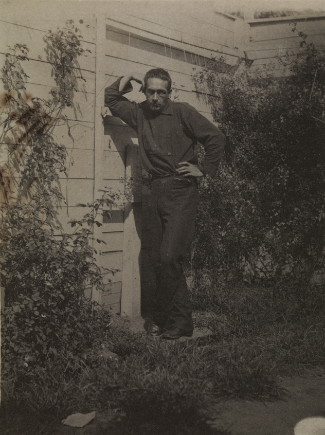 Thomas Eakins at about age thirty-five, leaning against fence