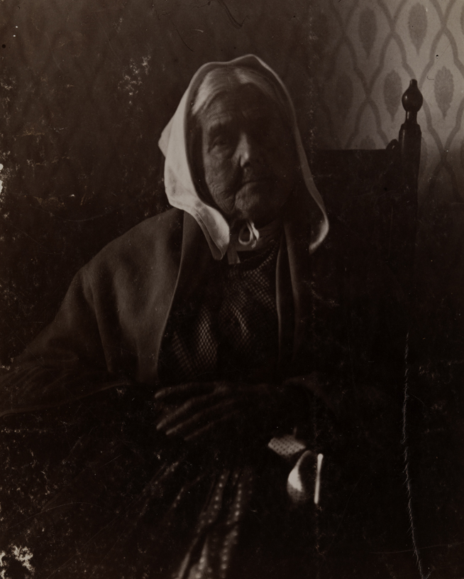 Old woman with white kerchief, sitting
