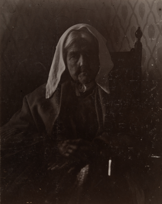 Old woman with white kerchief, sitting