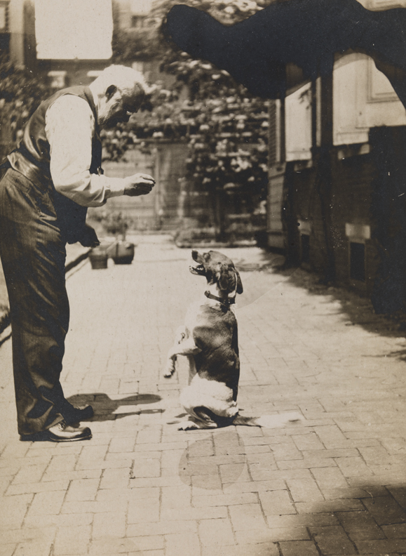 Thomas Eakins with his dog in yard of the family home at 1729 Mount Vernon Street, Philadelphia