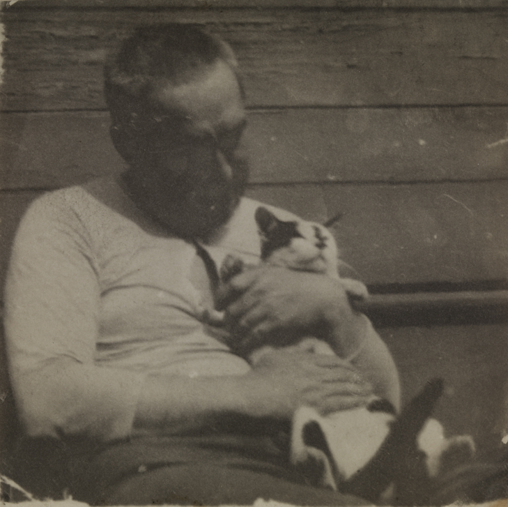 Thomas Eakins fondling a cat