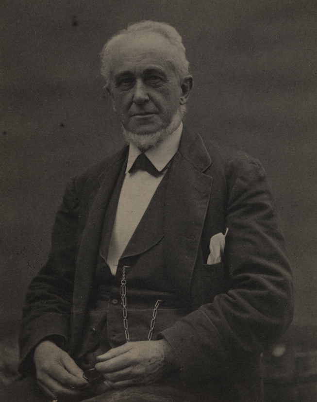Benjamin Eakins in dark suit, sitting