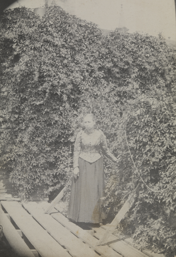 The artist's mother standing in yard
