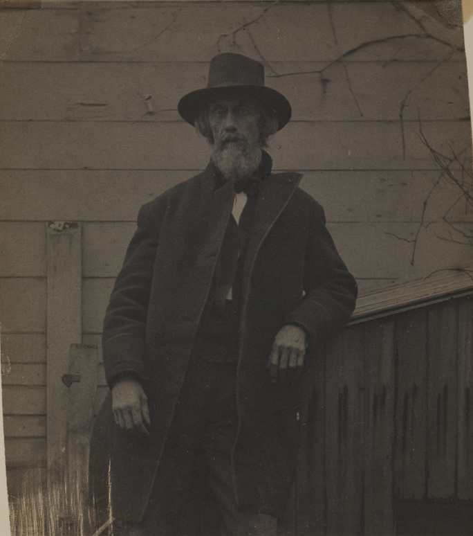 William H. Macdowell in coat and hat, standing in yard of the Eakins family home at 1729 Mount Vernon Street, Philadelphia