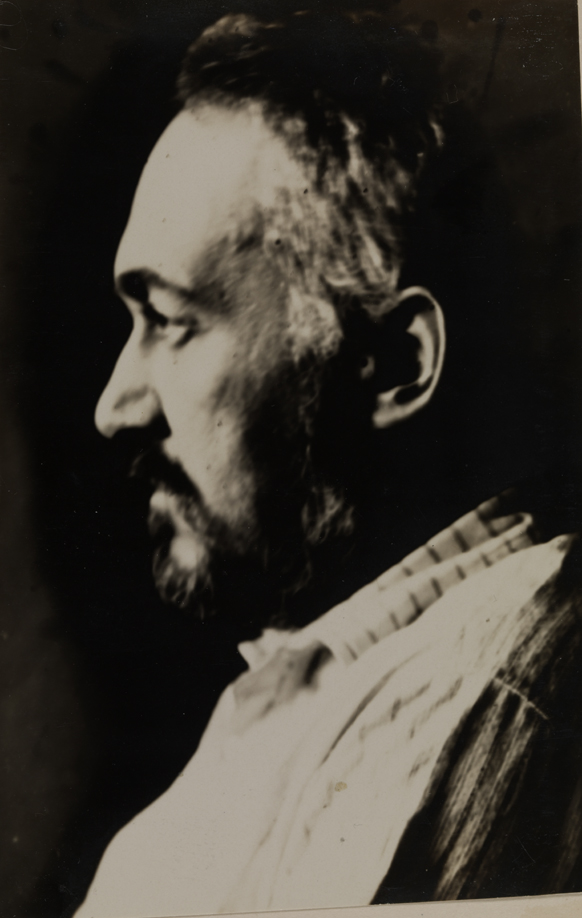 Thomas Eakins in striped shirt, sitting in profile
