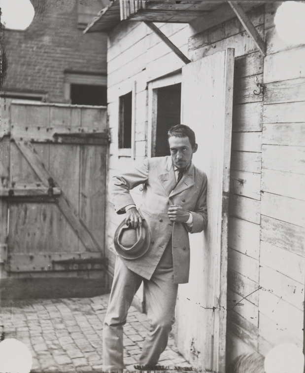 Thomas Eakins leaning against building