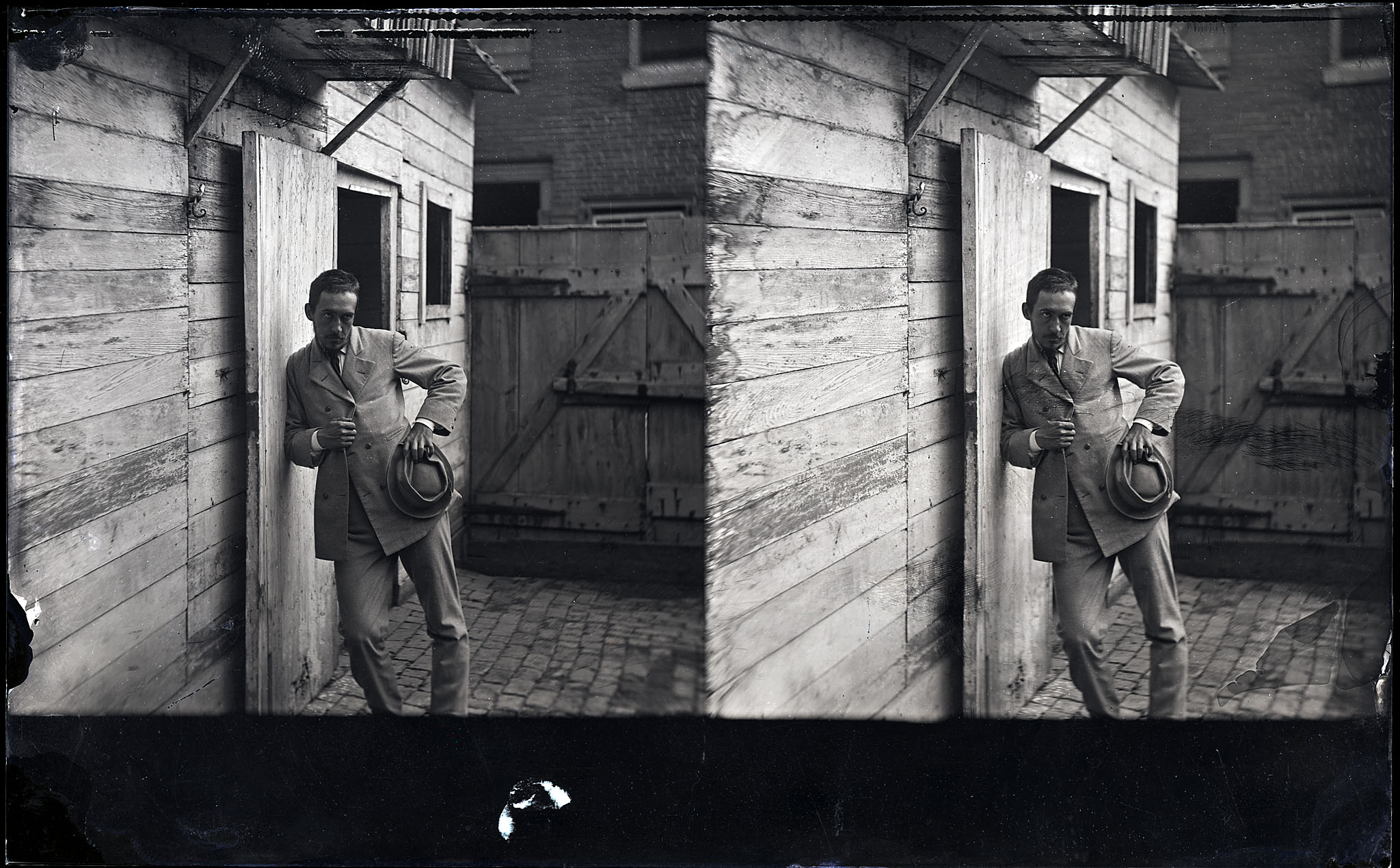 Thomas Eakins leaning against building