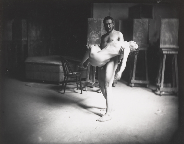 Thomas Eakins nude, holding nude female in his arms, looking at camera
