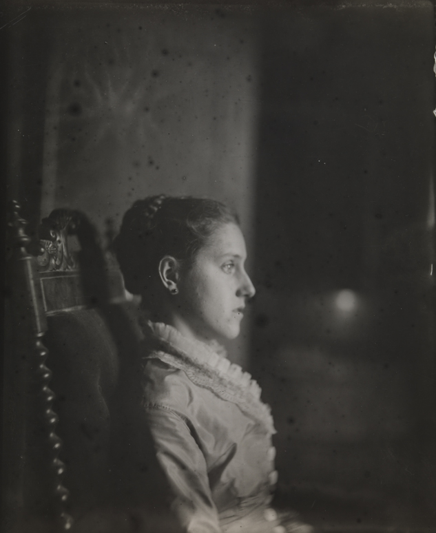 Margaret Harrison in profile, sitting in carved armchair