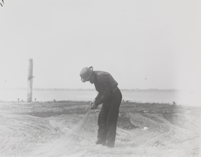 Fisherman mending a net