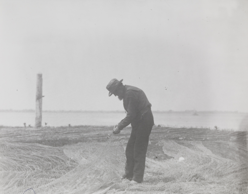 Fisherman mending a net