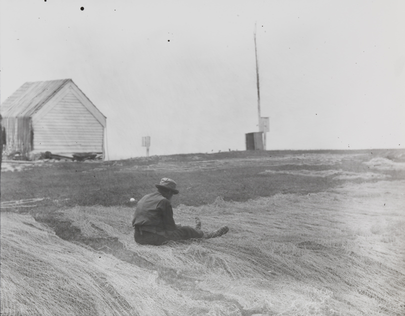 Fisherman mending a net