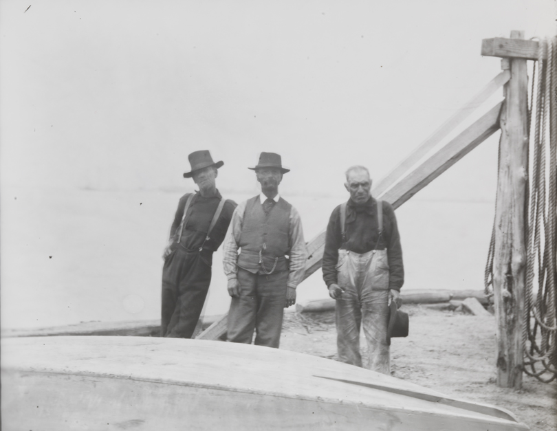 Three fishermen standing at edge of Delaware River