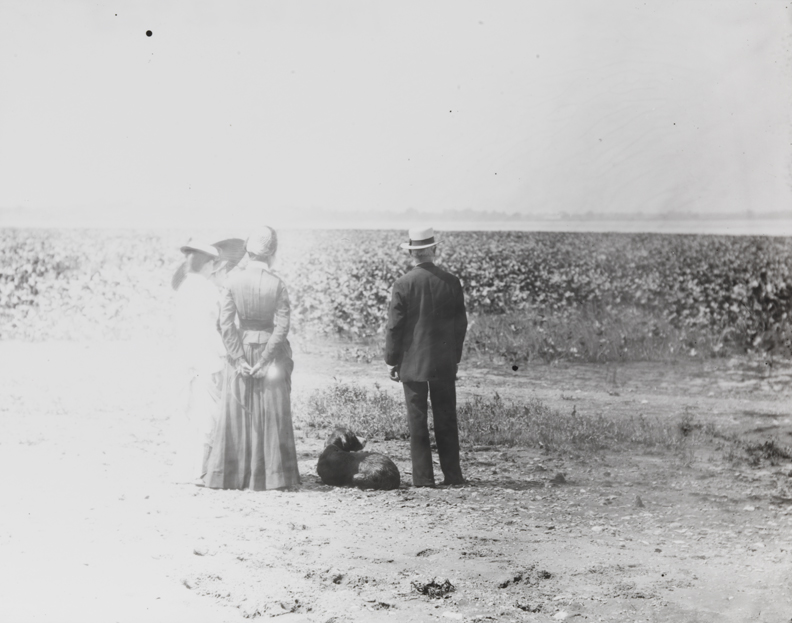 Three women, man, and dog near Delaware River
