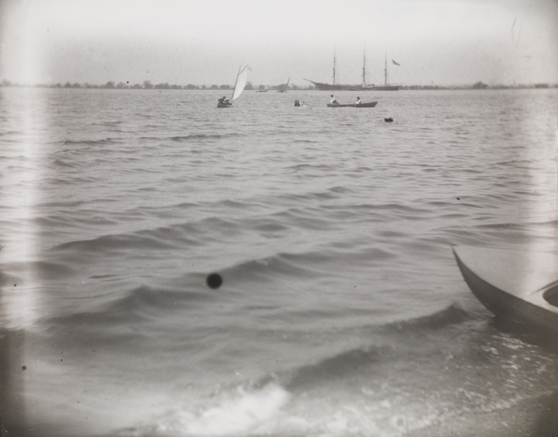 Delaware River with small sailboat on port tack