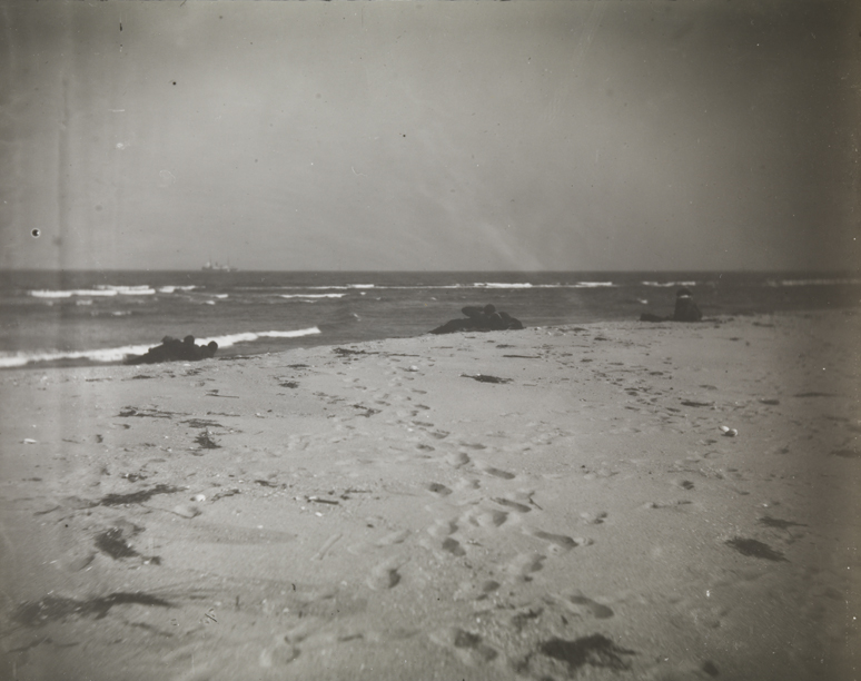 Beach scene with several groups of reclining figures