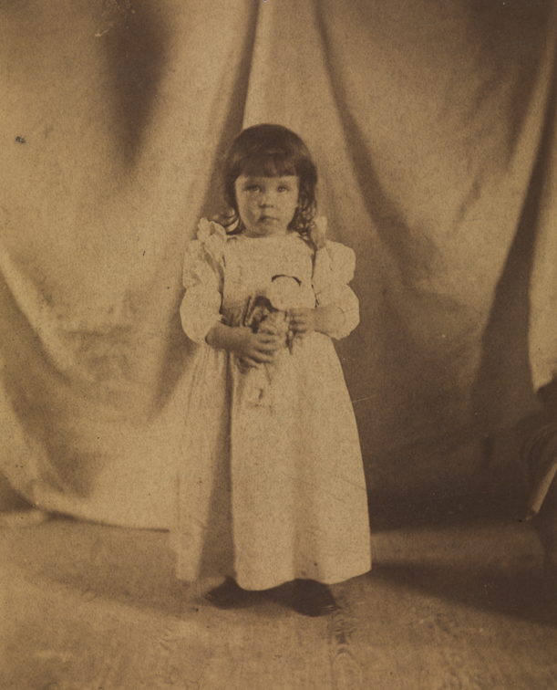 Marian Willoughby Josephs (standing, holding doll at her waist)