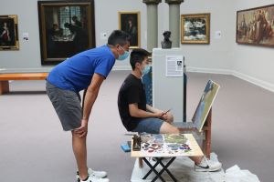 teacher with student in gallery