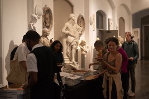 Students and other PAFA community members enjoying pizza in the historic Cast Hall.