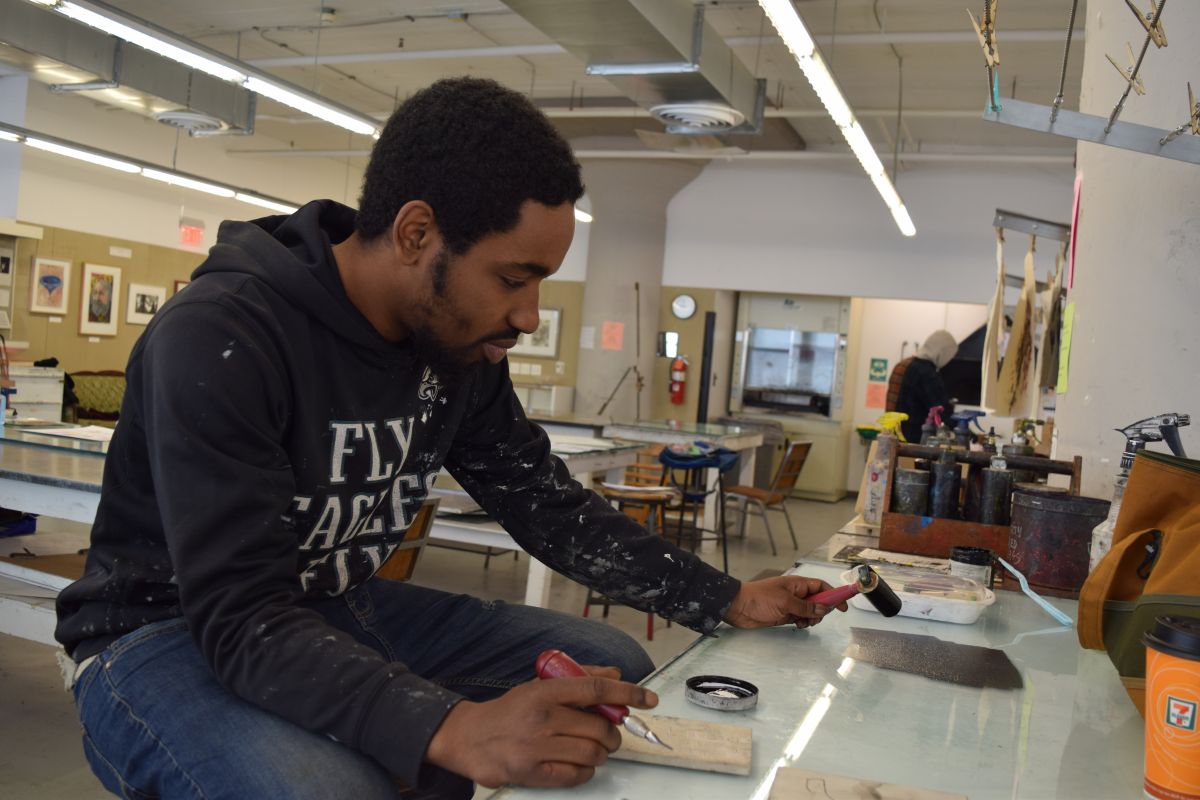 Lamar, a participant in the Restorative Justice Program, works in the print shop