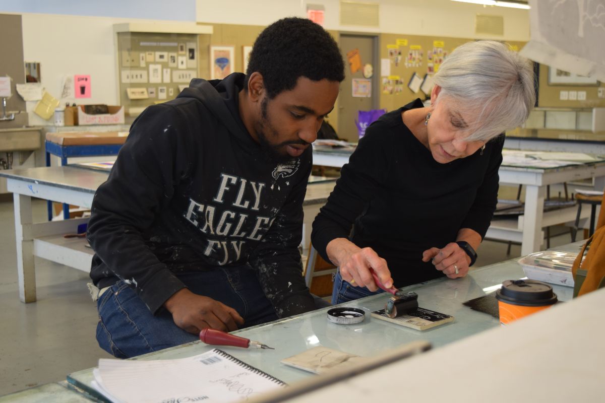 Lamar, a program participant, works in the print shop with PAFA alum Christine Stoughton