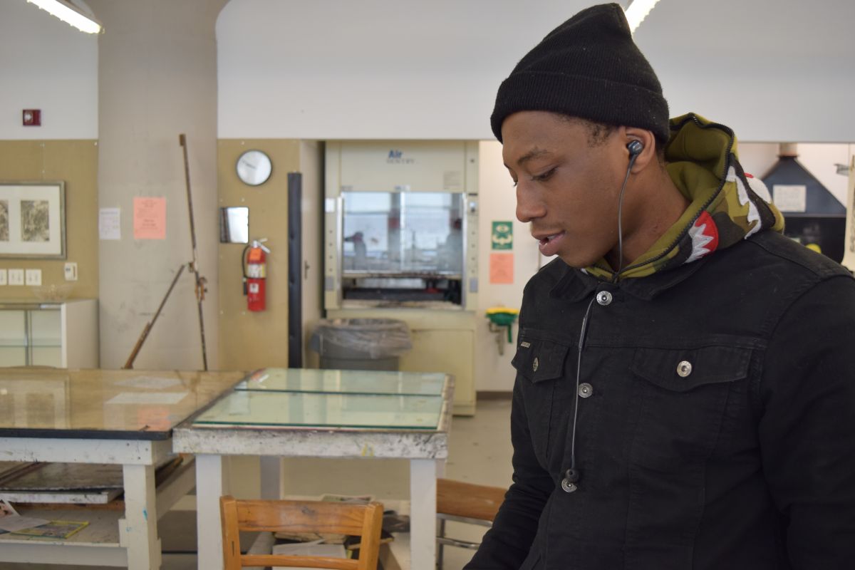 Aaron, a participant in the Restorative Justice Program, works in the print shop