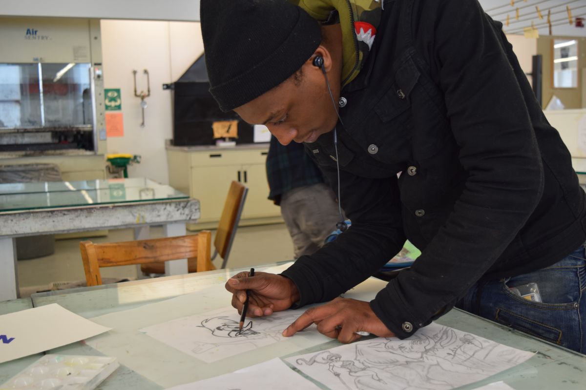 Aaron, a participant in the Restorative Justice Program, works in the print shop