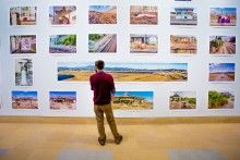 One person looking at the photos on the gallery wall