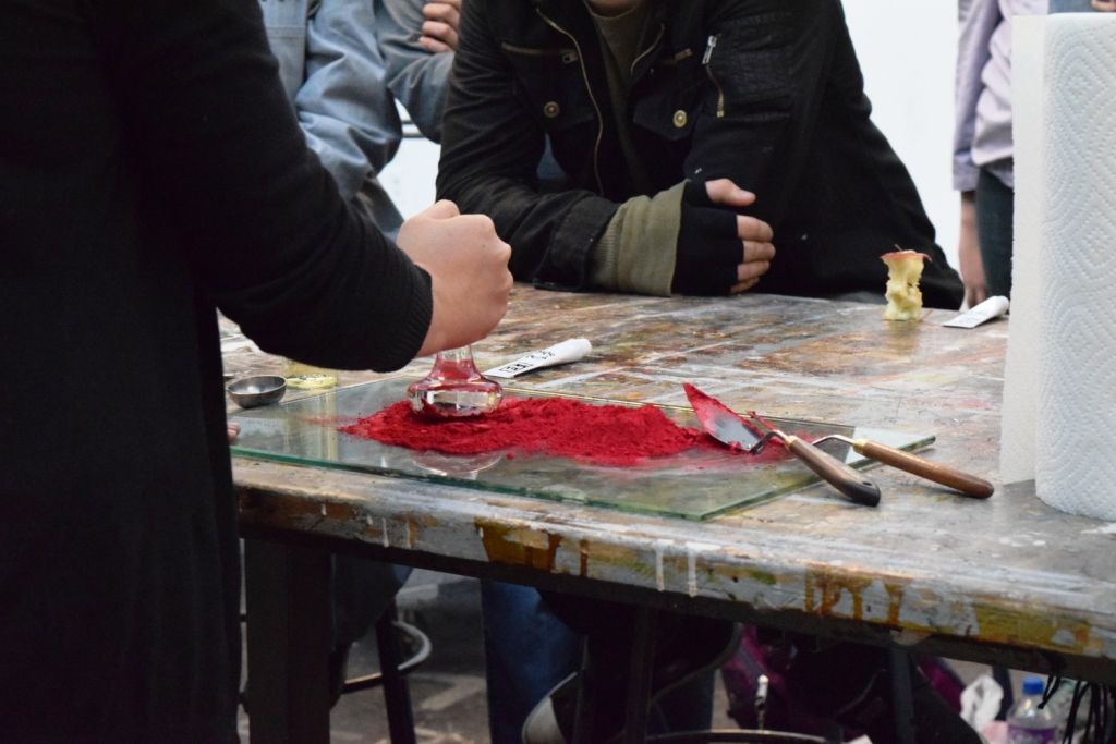 A close up shot of paint being made on a table