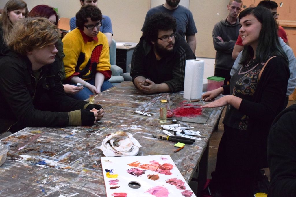 Liza Samuel shows off her paint to students