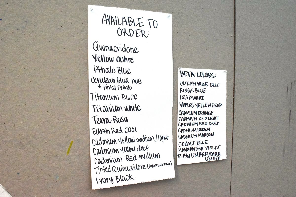 Two lists of paints available for order written on white paper with black ink