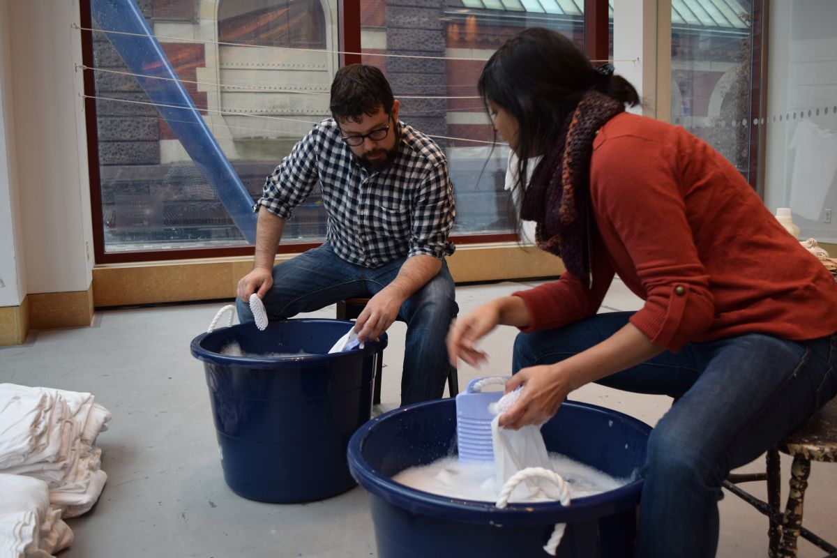  woman and man washing and talking