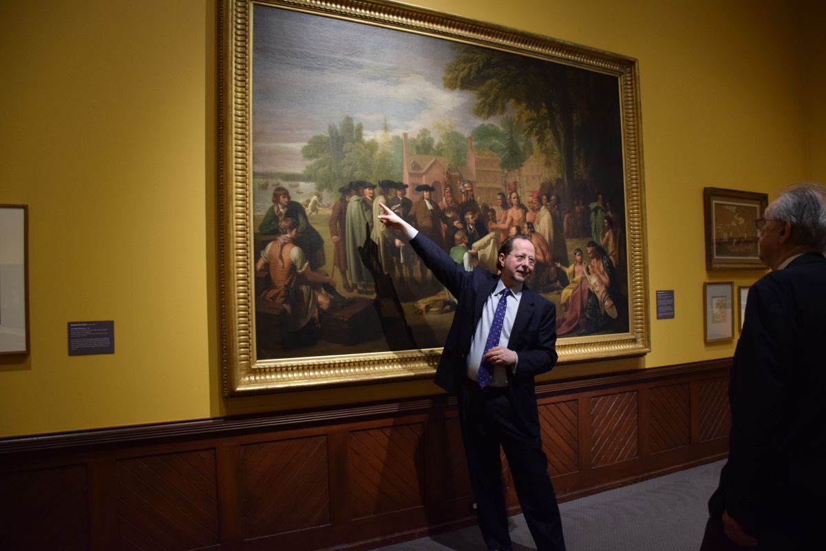David Brigham, CEO and President of PAFA, guides visitors through a painting