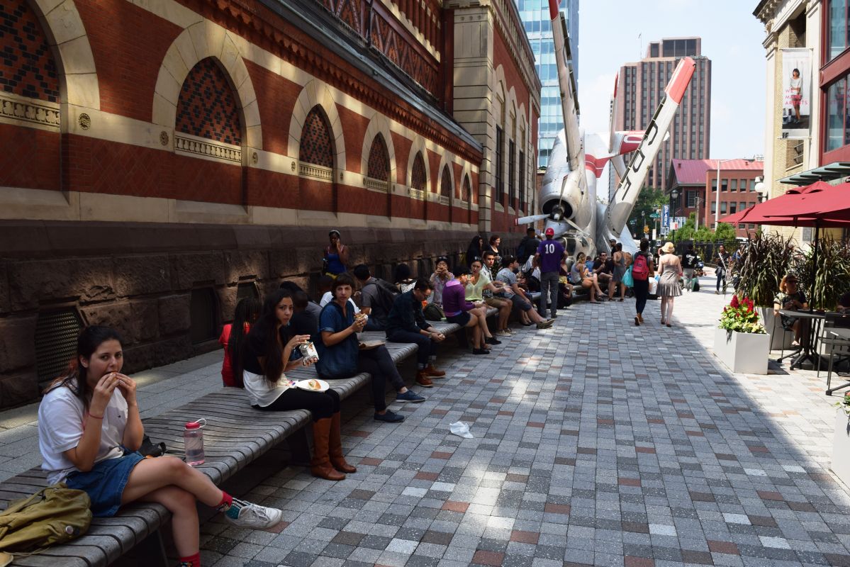 People sitting on the sidewalk on the PAFA campus