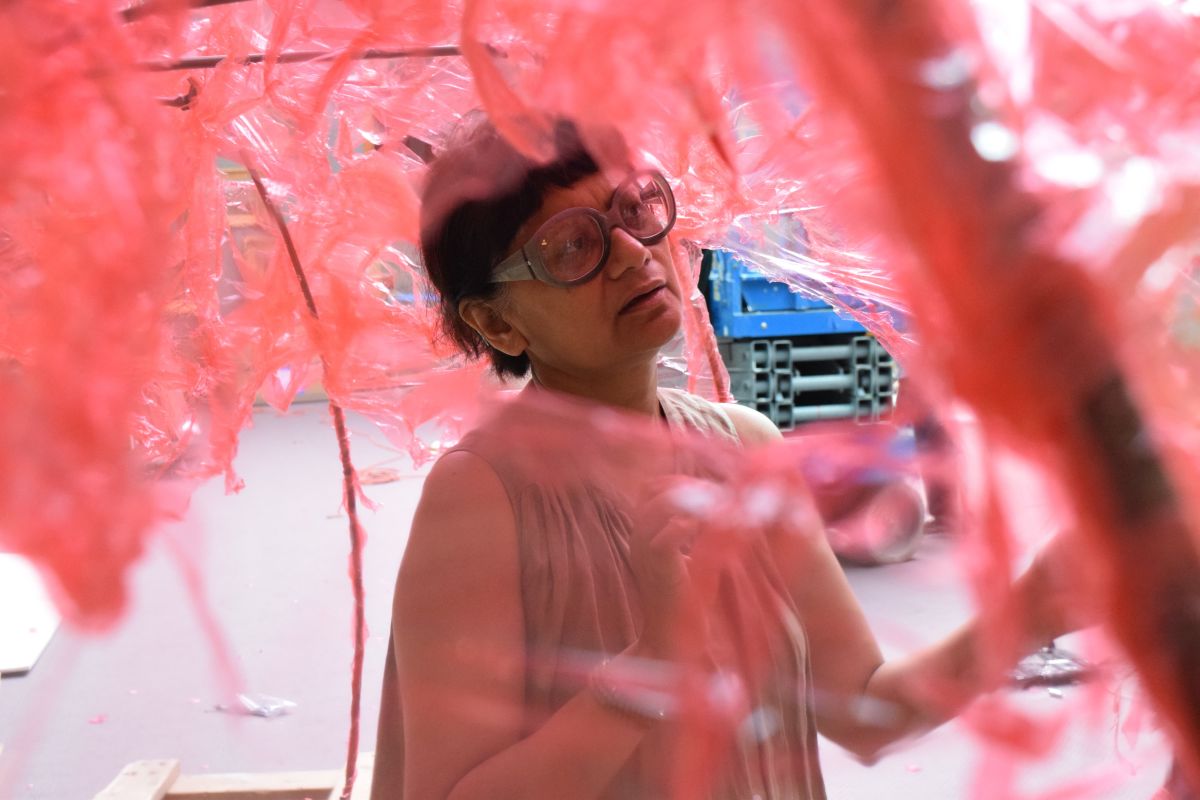 Artist Rina Banerjee installs "Take me...," an 18-foot recreation of the Taj Mahal constructed out of pink cellophane.