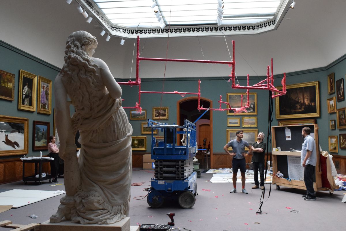 PAFA's installation team overseeing the construction of Banerjee's work.