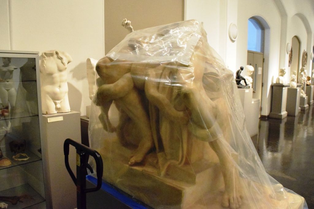 The assembled artwork wrapped in plastic and on a moving dolly
