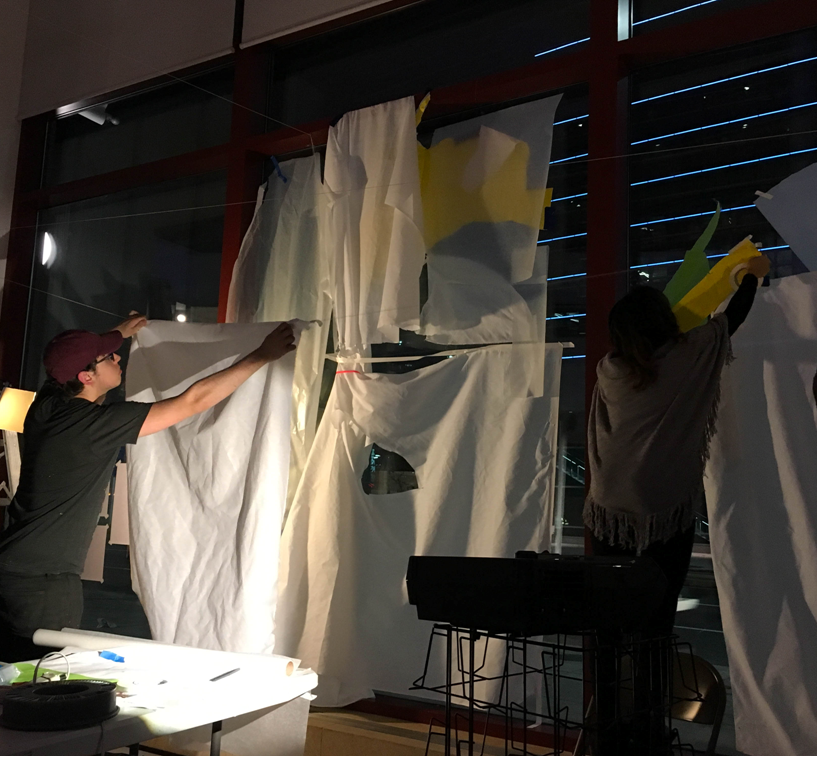 Two people work on art at the Broad Street Studio