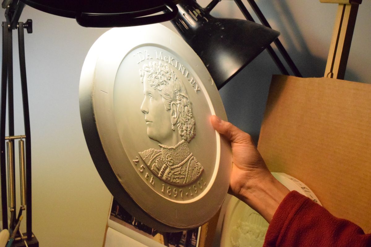 Phebe Hemphill holds a work in one hand