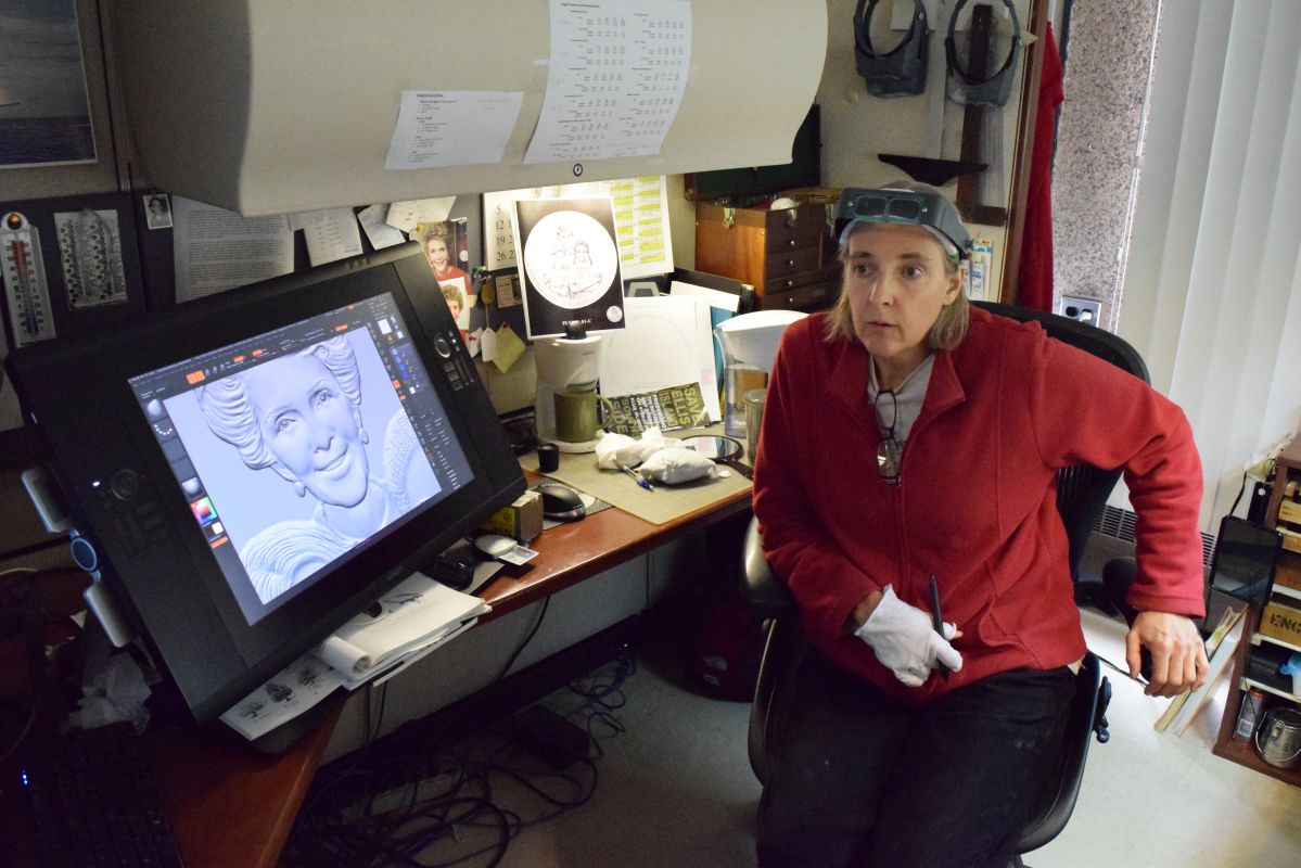 Phebe Hemphill sitting in front of a laptop on a desk