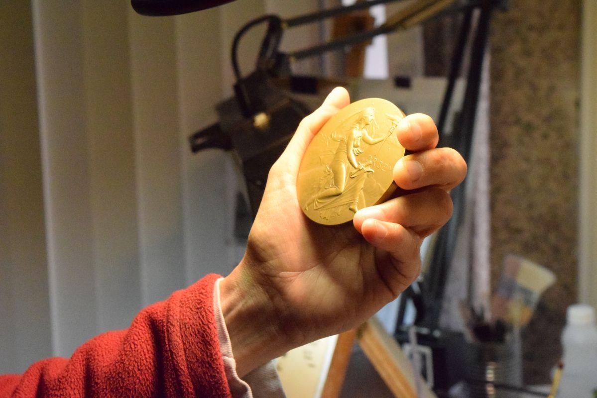 Phebe Hemphill holds a small work in one hand