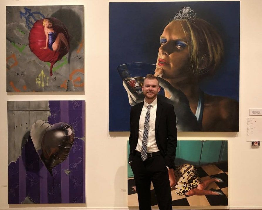 Collin Cousart (BFA '18) poses with their work at the ASE.