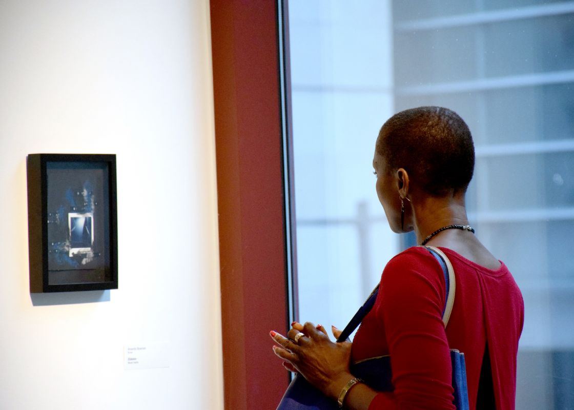 A visitor looks at piece by Amanda Bowman in the "Insider Art" exhibition.