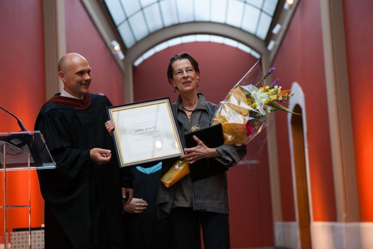 Jody Pinto receives an award for her 40 years of service at PAFA.